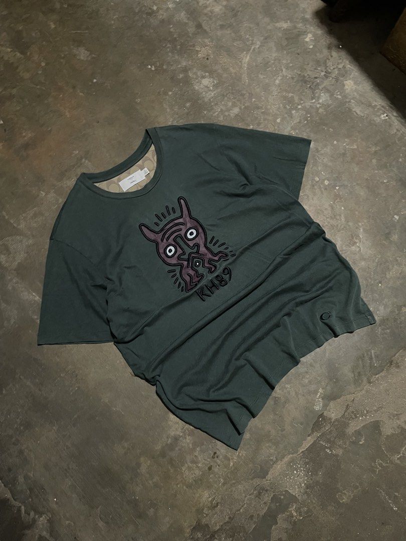 Coach x Keith Haring Graphic Tee Dark Green (Category: Tshirts & Polo Shirts ) located in Santa Cruz. Submitted by _darskieeezz (Listing ID 1461969303, Image 1). Description: Actual Dimes 21 by 27 medium Embroidered Design Looks great!.