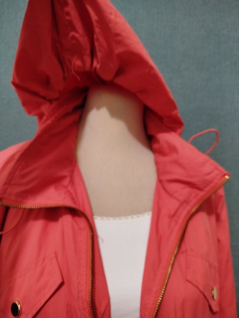 Coral Hooded Drawstring Jacket with Gold Zippers (Category: Coats, Jackets and Outerwear) located in Quezon City. Submitted by plus4lessshop (Listing ID 1461837696, Image 3). Description: - Coral colored jacket - Attached hood - Drawstring waist for adjustable fit - Gold zippers on pockets and front closure - Sleeves can be rolled up and secured with button tabs - Lightweight material, ideal for layering - Perfect for casual outings.