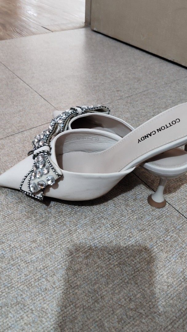 Cotton Candy Mules with Rhinestone Bow Detail (Category: Flats & Sandals) located in Paranaque City. Submitted by fourMs (Listing ID 1461903080, Image 3). Description: - Brand: Cotton Candy - Style: Mules - Design: Pointed toe - Embellishment: Sparkly rhinestone bow on the front - Heel: Low heel (easy to walk in) - Occasion: Perfect for dressing up outfits, parties, or nights out.