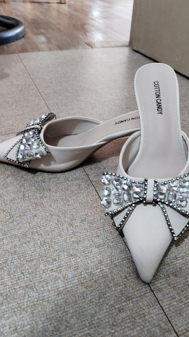 Cotton Candy Mules with Rhinestone Bow Detail (Category: Flats & Sandals) located in Paranaque City. Submitted by fourMs (Listing ID 1461903080, Image 2). Description: - Brand: Cotton Candy - Style: Mules - Design: Pointed toe - Embellishment: Sparkly rhinestone bow on the front - Heel: Low heel (easy to walk in) - Occasion: Perfect for dressing up outfits, parties, or nights out.