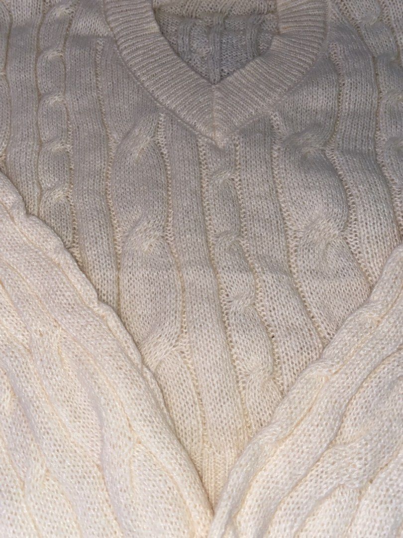 Cream Cable Knit V-Neck Sweater (Category: Coats, Jackets and Outerwear) located in San Jose del Monte. Submitted by skyarraa (Listing ID 1461880319, Image 2). Description: - Cream colored sweater - Classic cable knit pattern - V-neckline - Long sleeves - Cozy and warm feel - Versatile for layering or standalone wear - Easy to style with jeans or skirts.