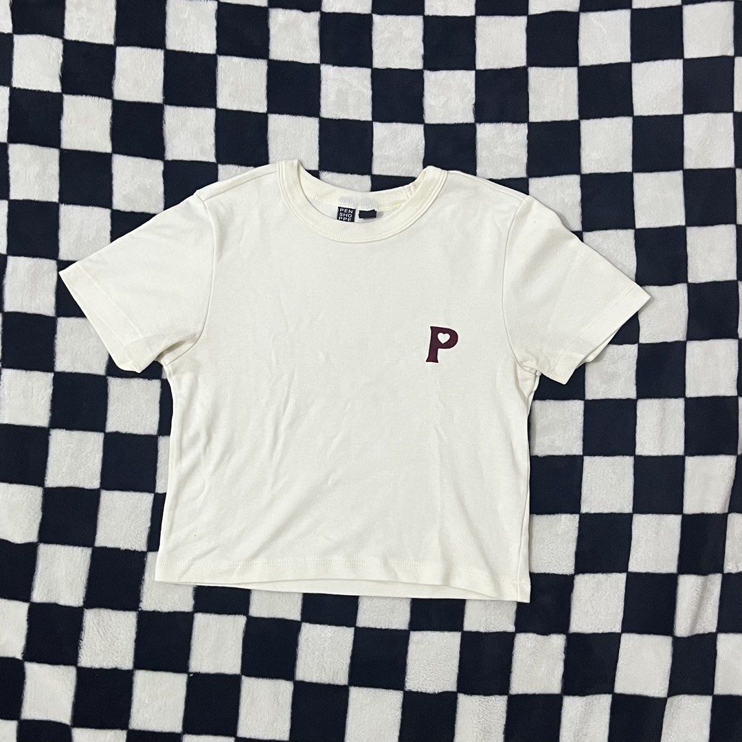 Cream Cropped T-shirt (Category: Shirts) located in Manila. Submitted by luvchinchin (Listing ID 1461967832, Image 1). Description: - Cream colored t-shirt - Small maroon 'P' logo on chest - Short sleeves - Crew neck - Comfortable for everyday casual wear - Brand tag visible (small text).