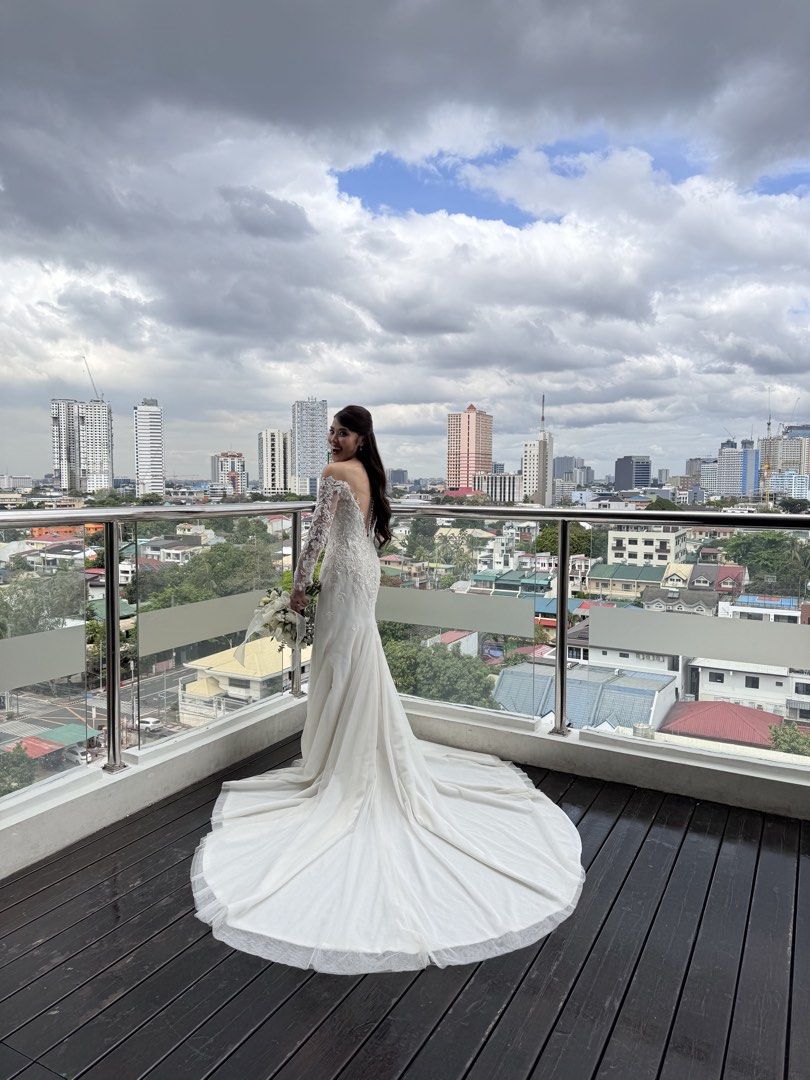 CUSTOM WEDDING GOWN FOR SALE (Category: Evening dresses & gowns) located in Quezon City. Submitted by jdeauna (Listing ID 1461838496, Image 3). Description: 🤍 CUSTOM WEDDING GOWN FOR SALE Letting go of my custom-made wedding gown, worn once last February 2025. 🤍 Details: • Off-shoulder neckline • Long sheer lace sleeves • Intricate lace • Fit-and-flare / mermaid-inspired silhouette • Low back with button detailing • Extended train • Ivory/champ