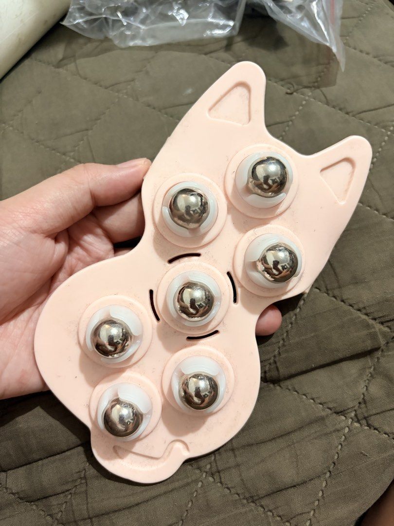 Cute Cat Shaped Massage Roller with Metal Balls (Category: Massage Devices) located in Manila. Submitted by finderskeepersmnl_092026 (Listing ID 1461967540, Image 1). Description: - Adorable pink cat-shaped massager - Features 6 smooth-rolling metal balls - Ideal for relaxing massages on neck, shoulders, and arms - Ergonomic design for easy holding and use - Compact and portable for on-the-go de-stressing - A fun way to unwind and relieve tension