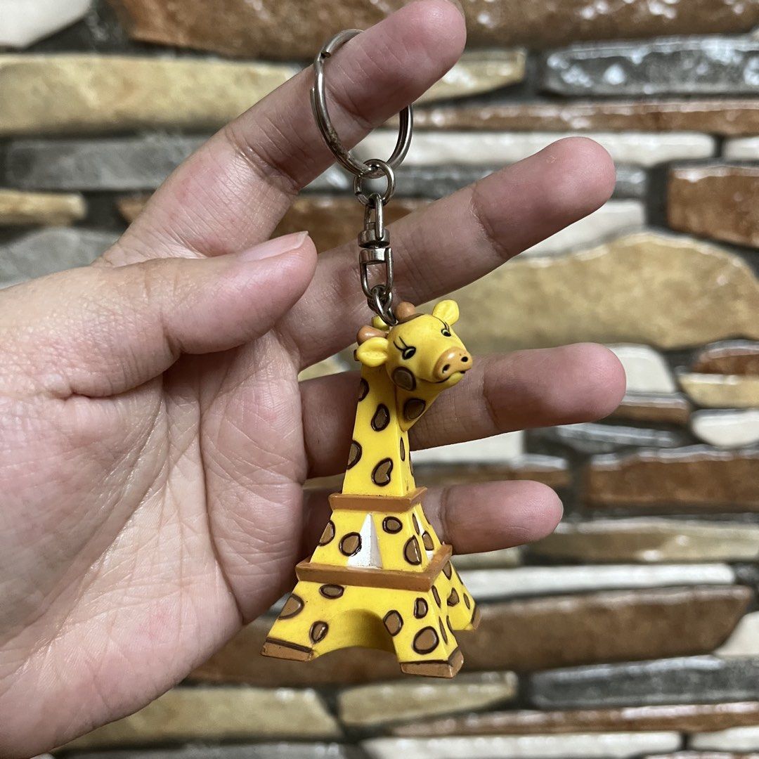 Cute Giraffe Eiffel Tower Keychain (Category: Character Goods) located in San Pedro. Submitted by rainyydayy (Listing ID 1461091677, Image 1). Description: - Adorable giraffe Eiffel Tower keychain - Bright yellow with brown spots - Great for decorating bags or keys - Fun and quirky accessory - Unique souvenir piece.