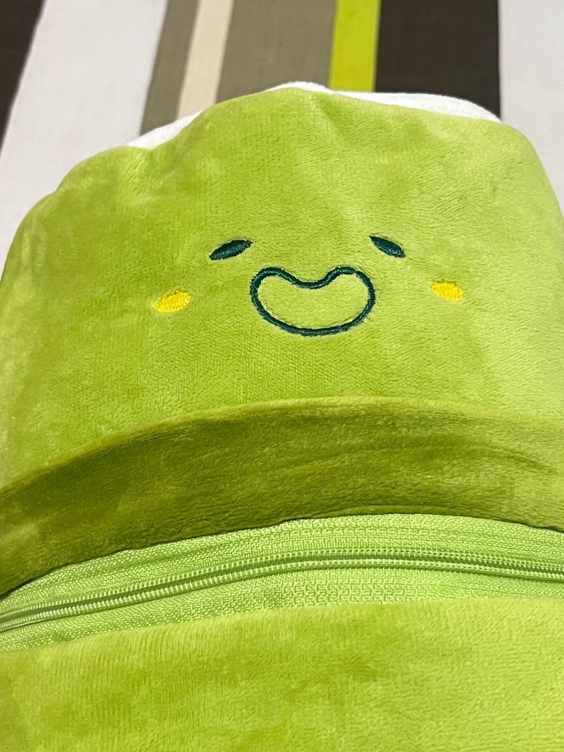 Cute Plushie Pouch (Category: Plushies & Soft Toys) located in Santa Rosa. Submitted by rsxyen (Listing ID 1461992541, Image 2). Description: - Adorable green plush character with a cheerful expression. - Zippered opening reveals a spacious interior. - Interior lined with a cute checkered pattern. - Versatile use: great for storing small items or as a fun decor piece. - Perfect gift for children or enthusiasts of cute plush toys..