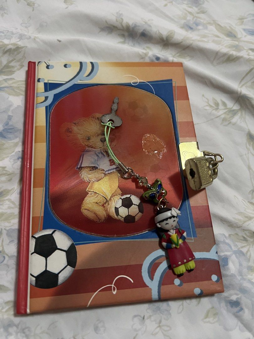 Cute Teddy Bear Diary with Lock and Key (Category: Stationery & School Supplies) located in San Juan City. Submitted by iambernie (Listing ID 1462034538, Image 1). Description: - Adorable teddy bear and soccer themed diary - Comes with a small lock and key for privacy - Features a cute charm attached - Lined pages, ideal for journaling - pages have come off .