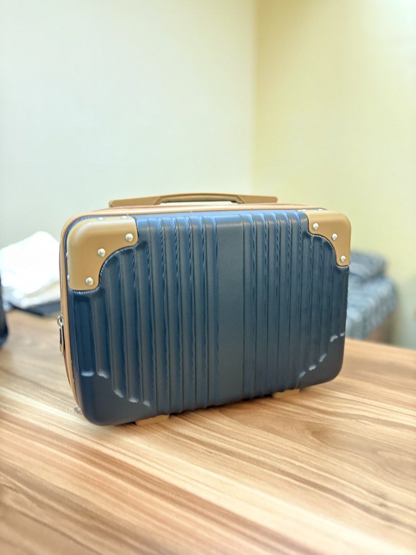 Dark Blue and Tan Hard Shell Luggage (Category: Luggage) located in Manila. Submitted by amityclutter (Listing ID 1461938213, Image 1). Description: - Compact hard shell luggage - Dark blue body with tan accents - Ribbed texture on the front - Carry-on size, ideal for short trips - Can also be used as a makeup case - Clean interior, ready for use.