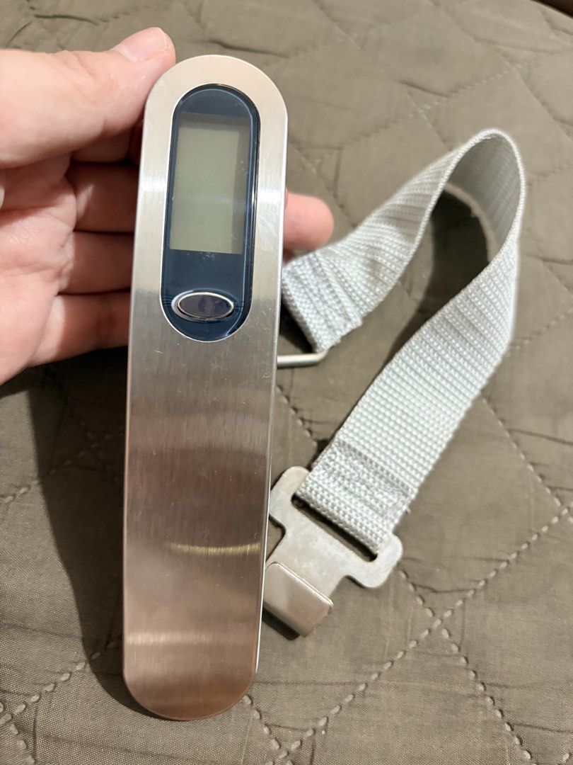 Digital Luggage Scale with Strap (Category: Travel Essentials & Accessories) located in Manila. Submitted by finderskeepersmnl_092026 (Listing ID 1461967903, Image 1). Description: - Portable digital scale for luggage - Includes sturdy strap and metal hook - Clear LCD display for easy reading - Compact and lightweight for travel - Helps avoid overweight baggage fees - Battery operated.