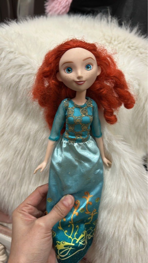 Disney Brave Merida Doll (Category: Figurines & Statues) located in Batangas. Submitted by nommi26 (Listing ID 1461965910, Image 2). Description: WYSIWYG - Merida doll from Disney's Brave - Signature curly red hair and blue eyes - Wears iconic blue dress with gold accents - Hair is a bit messy but still looks great - Ideal for any Disney fan.