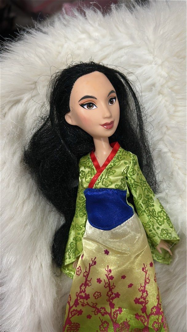 Disney Mulan Doll (Category: Figurines & Statues) located in Batangas. Submitted by nommi26 (Listing ID 1461966730, Image 1). Description: WYSIWYG - Mulan doll in her traditional outfit - Features a green patterned robe with a blue sash - Yellow skirt adorned with pink floral accents - Long, flowing black hair - Ideal for collectors or for playtime.