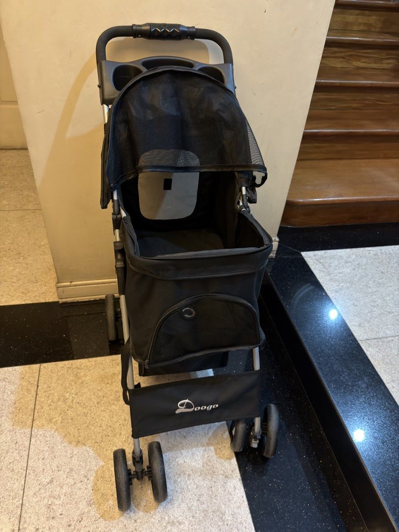 Doogo Pet Stroller - Black (Category: Homes & Other Pet Accessories) located in Quezon City. Submitted by tanyasy_52 (Listing ID 1461904562, Image 2). Description: - Black Doogo pet stroller - Mesh top for ventilation and visibility - Bottom storage basket included - Handlebar with cup holders - Easy to fold and transport - Perfect for taking your pet out price negotiable.
