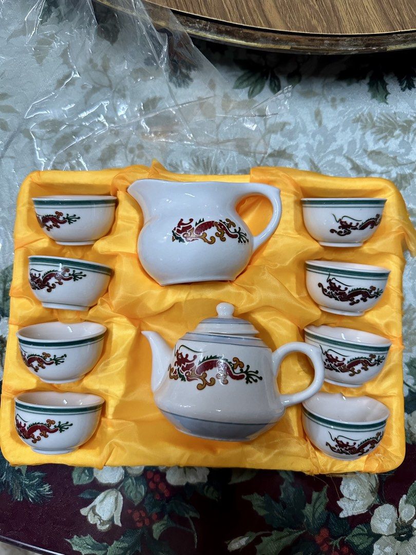 Dragon Like Design Tea Set with Teapot and Cups (Category: Coffee & Tea Tableware) located in Manila. Submitted by aj.honey (Listing ID 1461811038, Image 1). Description: - Exquisite white ceramic tea set - Features a vibrant red and gold dragon design - Set includes: 1 teapot, 1 creamer pitcher, 6 small cups - Cups have a delicate green trim - Comes in a luxurious yellow satin-lined box.