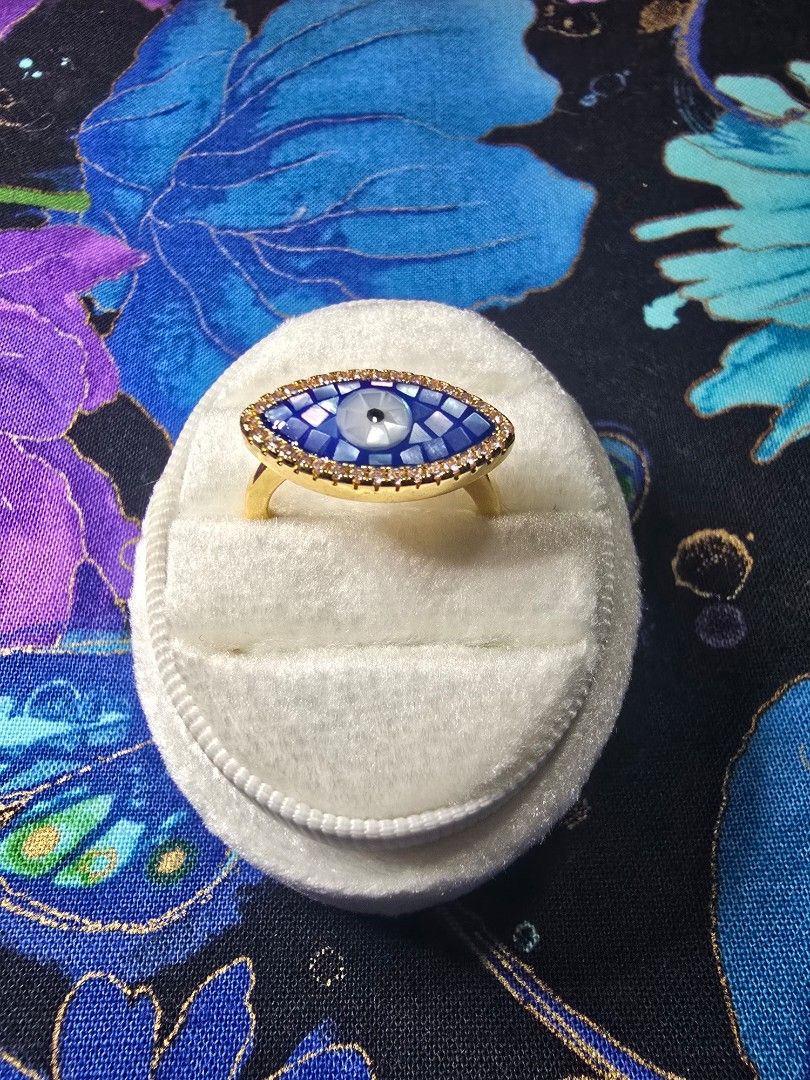 Evil Eye Ring with Blue Mosaic and Rhinestones (Category: Rings) located in Santa Rosa. Submitted by crystal1.0 (Listing ID 1461943379, Image 1). Description: - Gold-tone band ring - Blue evil eye design - Outlined with small clear rhinestones - Blue mosaic center with white pupil detail - Statement piece for a pop of color - Suitable for everyday wear or special occasions - Mother of Pearl material - open bangle ring - stainless steel.