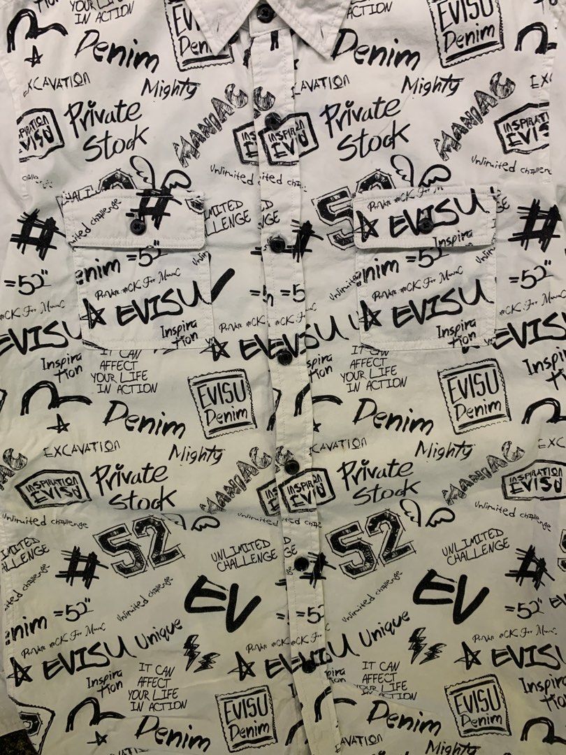 EVISU All Over Print White Button Up Shirt (Category: Tshirts & Polo Shirts ) located in Manila. Submitted by loyspalencia (Listing ID 1461850536, Image 3). Description: - White Evisu shirt - Black all-over graphic print featuring Evisu branding and text - Button-up front - Chest pockets - Size: 95 (Medium) - Ideal for casual wear - Dimes: W-19 / L-24 / Sleeve-21.