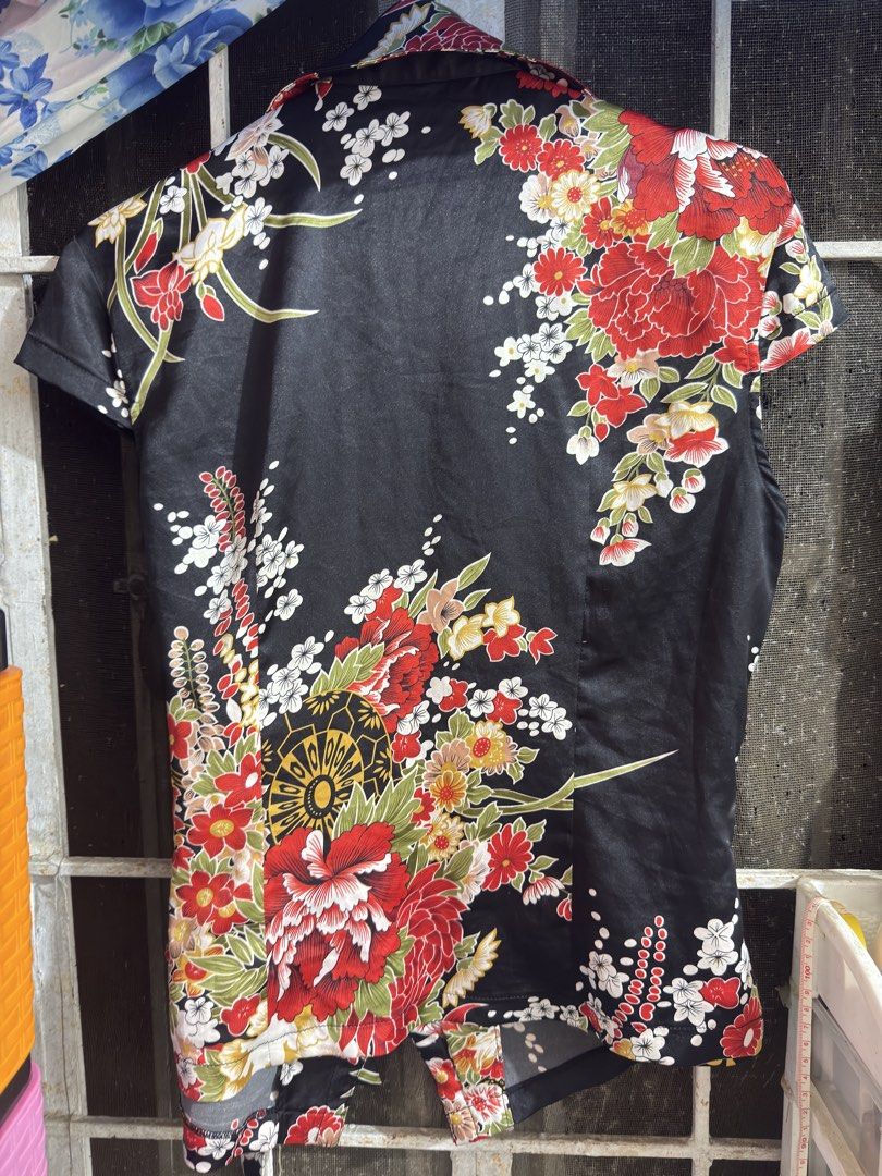 Flowy Floral Wrap Chinese Top with Tie (Category: Blouses) located in Cavite. Submitted by chikzie (Listing ID 1461998003, Image 2). Description: - Black wrap top - Vibrant floral print - Short sleeves - Adjustable waist tie - Fabric with a subtle sheen - Versatile: dress up or down - Pairs well with jeans or skirts.