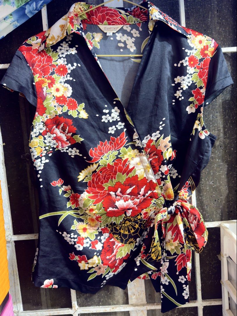 Flowy Floral Wrap Chinese Top with Tie (Category: Blouses) located in Cavite. Submitted by chikzie (Listing ID 1461998003, Image 1). Description: - Black wrap top - Vibrant floral print - Short sleeves - Adjustable waist tie - Fabric with a subtle sheen - Versatile: dress up or down - Pairs well with jeans or skirts.