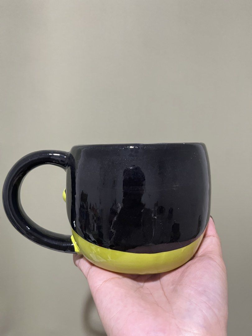 Frankenstein Halloween Ceramic Mug (Category: Coffee & Tea Tableware) located in Manila. Submitted by vaughnscloset (Listing ID 1461948829, Image 2). Description: - Fun Frankenstein mug - Bright green face with black hair and handle - Ideal for Halloween or year-round spooky vibes - Suitable for coffee, tea, or hot chocolate - Dishwasher safe (handwashing recommended for longevity) - A unique addition to your kitchenware.