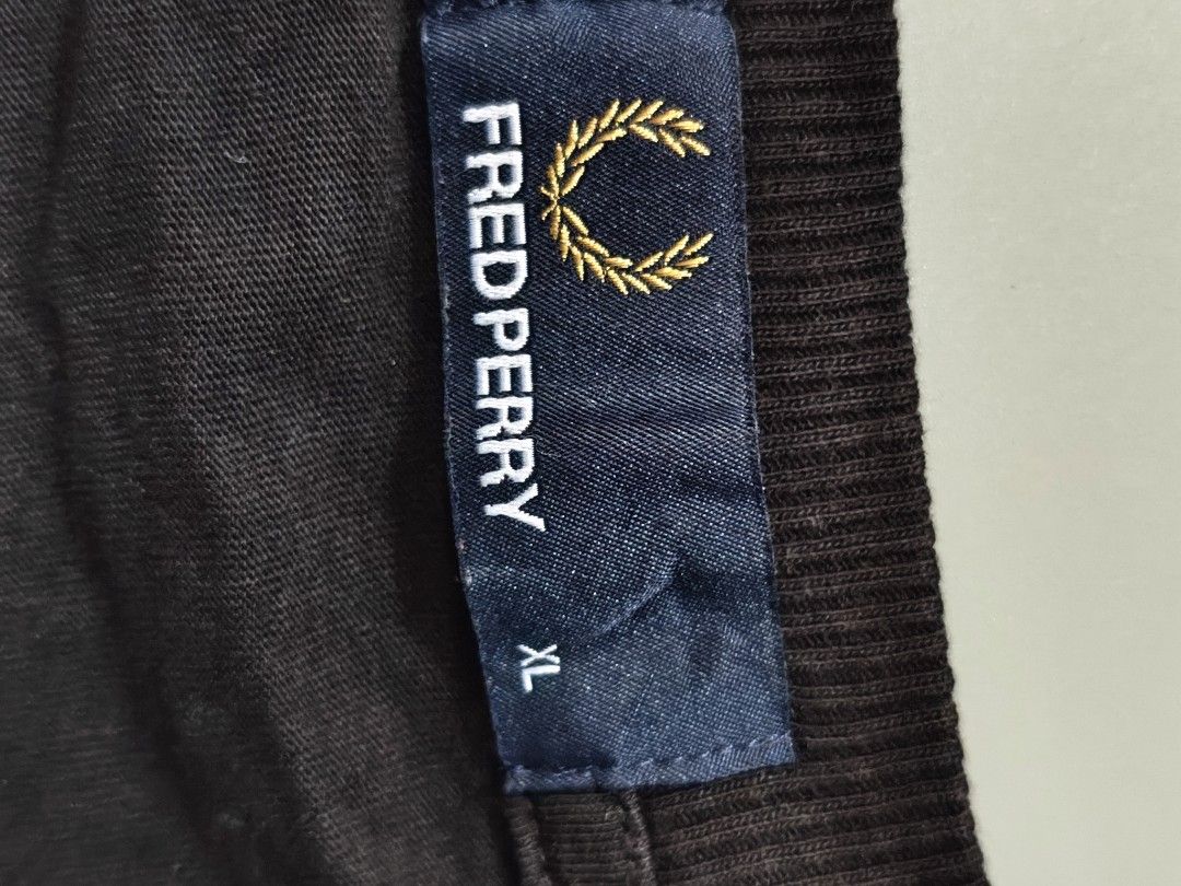 Fred Perry Black T-Shirt Size L (Category: Tshirts & Polo Shirts ) located in Quezon City. Submitted by rezno (Listing ID 1462016392, Image 2). Description: - Brand: Fred Perry - Color: Black - Size: XL (Tag) - Measurements: 22 inches (width) x 28 inches (length) - Material: 100% Cotton - Features: Iconic black laurel wreath logo - Style: Simple, classic, versatile staple piece.