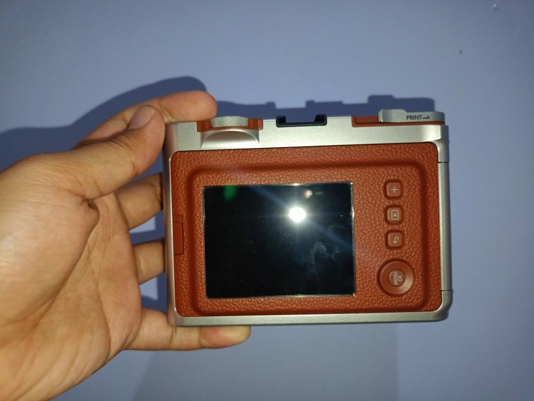 Fujifilm Instax Mini Evo Hybrid Instant Camera with Case (Category: Cameras) located in Manila. Submitted by cutebunny_17 (Listing ID 1461852299, Image 3). Description: - Fujifilm Instax Mini Evo hybrid camera - Comes with a stylish brown leather case - Includes a convenient strap - Pack of 10s Instax Mini film included - with tempered glass on screen - Perfect for capturing and printing memories instantly - Just 1 month old, used twice or thrice