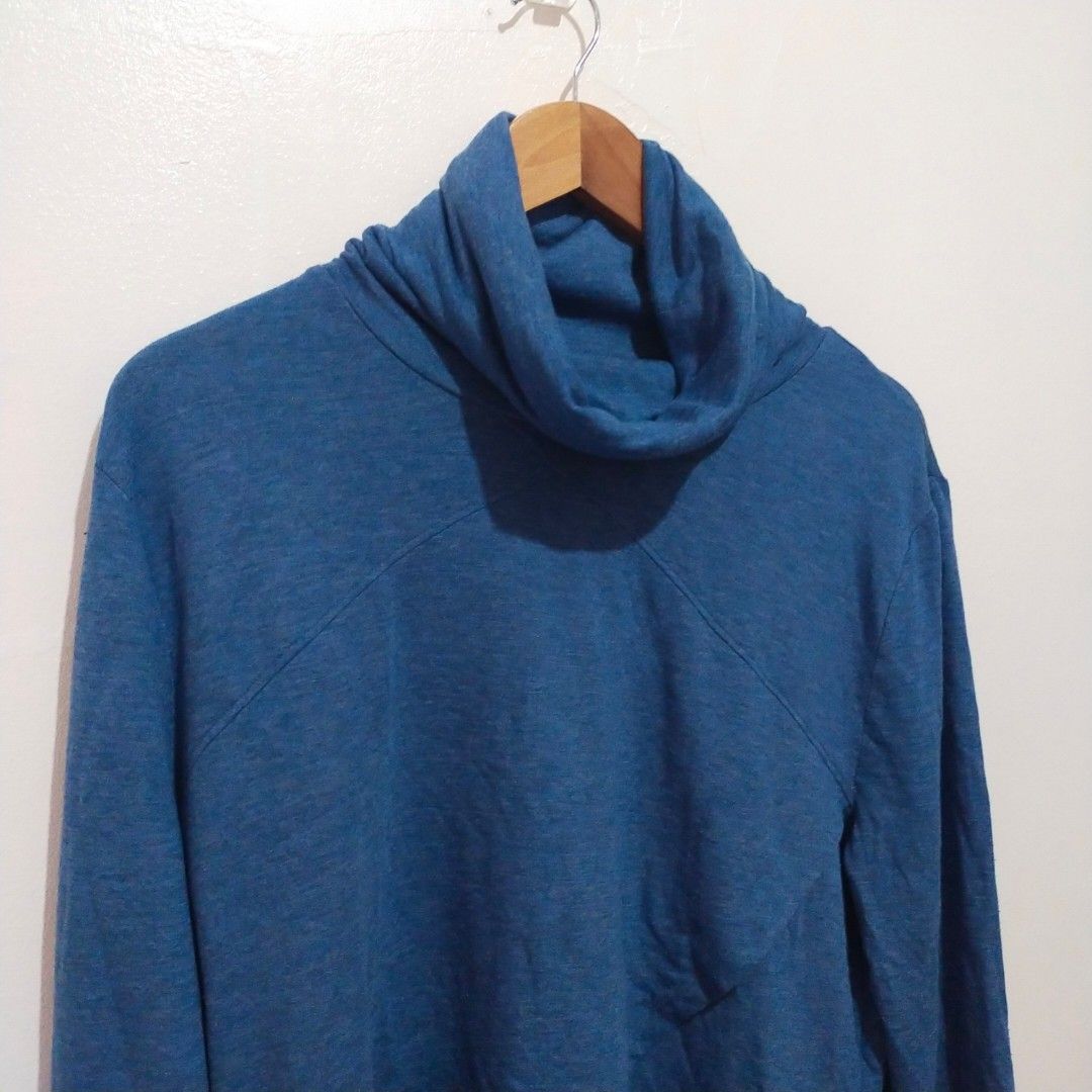 George Cowl Neck Asymmetrical Pullover (Blue/Heather Denim) (Category: Longsleeves) located in Subic. Submitted by mustardt_ (Listing ID 1461852476, Image 2). Description: A blue heather-knit long-sleeve top featuring a cozy cowl/funnel neck, an asymmetrical wrapped front hem, and thumbholes on the cuffs. size: 23in x 24in code: c735.