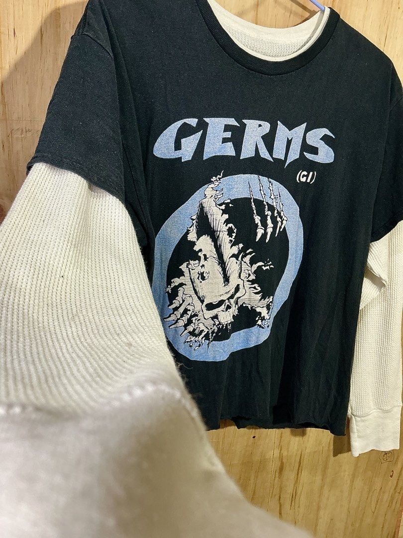 GERMS (GI) Double Layer Long Sleeve T-Shirt (Category: Tshirts & Polo Shirts ) located in Naga. Submitted by eunhasowon12391 (Listing ID 1461826215, Image 3). Description: - Black t-shirt with 'GERMS' band graphic print - Layered look with white long sleeves underneath - Raw hem for a edgy, punk rock style - Perfect for a cool, casual vibe.