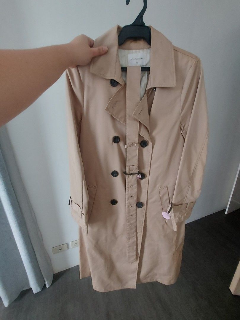 Glacier Beige Double-Breasted Trench Coat (Category: Coats, Jackets and Outerwear) located in San Pedro. Submitted by laine0728 (Listing ID 1461869644, Image 1). Description: - Classic beige trench coat from Glacier - Double-breasted design - Includes a belt to cinch the waist - Two front pockets - Button closure - Ideal for layering over any outfit - A timeless wardrobe essential - Bought in Tokyo, Japan - Used once - Original Price Php2,700.