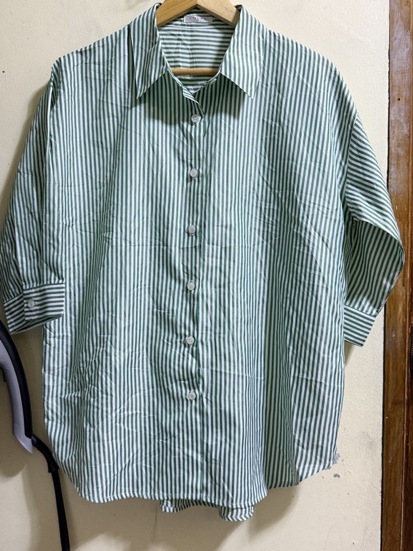 Green and White Striped Button-Up Shirt (Category: Shirts) located in Paete. Submitted by skydruemadison (Listing ID 1461922152, Image 1). Description: - Classic green and white striped button-up shirt - Collared neckline with front button closure - Three-quarter length sleeves with button cuffs - Lightweight and breathable fabric - Versatile for casual or semi-formal occasions - Pairs well with jeans or trousers.
