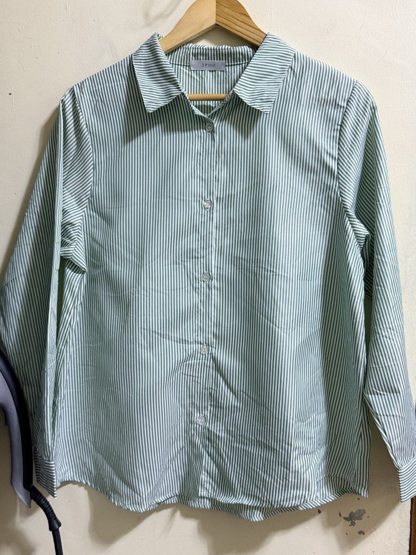 Green and White Striped Button-Up Shirt (Category: Shirts) located in Paete. Submitted by skydruemadison (Listing ID 1461922152, Image 3). Description: - Classic green and white striped button-up shirt - Collared neckline with front button closure - Three-quarter length sleeves with button cuffs - Lightweight and breathable fabric - Versatile for casual or semi-formal occasions - Pairs well with jeans or trousers.