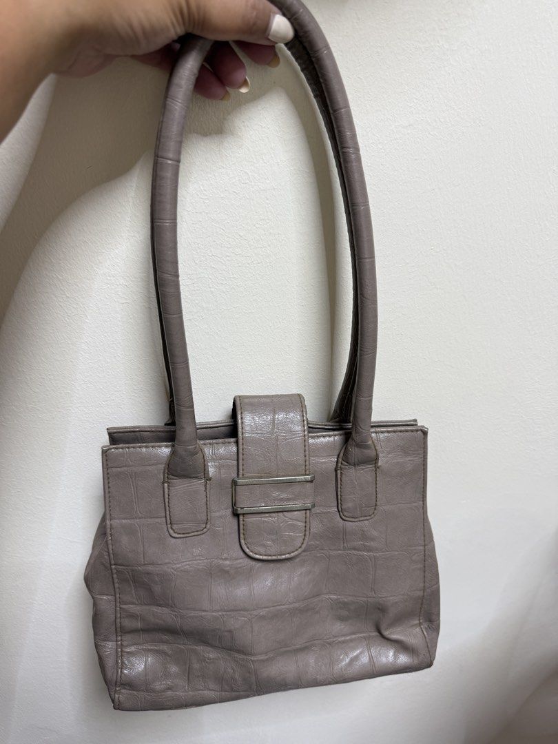 Grey Croc Embossed Shoulder Bag (Category: Shoulder Bags) located in Quezon City. Submitted by samutsariatpb (Listing ID 1461937995, Image 1). Description: - Chic grey shoulder bag - Elegant croc embossed texture - Secure flap closure with metal buckle - Comfortable shoulder straps - Classic and versatile design - Ideal for carrying daily essentials.