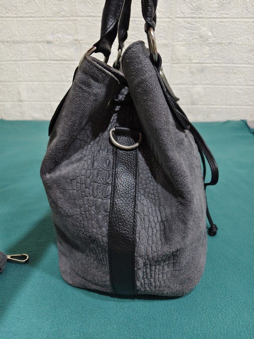 Grey Suede Crocodile Embossed Bucket Bag (Category: Cross-body Bags) located in Gamu. Submitted by charliecatvintagebags (Listing ID 1461818074, Image 3). Description: GENUINE LEATHER WALANG ISSUE - Grey suede bucket bag - Black leather trim - Crocodile embossed pattern on front - Drawstring closure - Detachable shoulder strap - Silver hardware - Roomy interior.