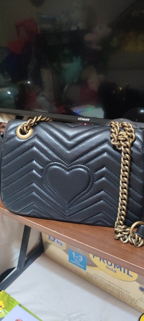 Gucci Marmont Black Leather Shoulder Bag (Category: Luxury Bags & Wallets) located in Pasig City. Submitted by xcess_baggage (Listing ID 1461822949, Image 3). Description: - Authentic Black Leather Gucci Marmont Bag - Iconic GG Logo on Front - Quilted Chevron Pattern - Heart Detail on Back - Gold Chain Strap - Interior Serial Numbers: 431382 965206 - Interior GUCCI Controllato Tag: 23456789 - Condition ( inner lining po may butas/ tastas, may min