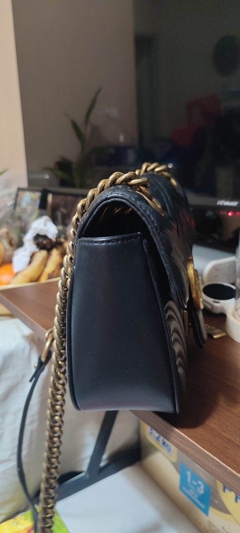 Gucci Marmont Black Leather Shoulder Bag (Category: Luxury Bags & Wallets) located in Pasig City. Submitted by xcess_baggage (Listing ID 1461822949, Image 2). Description: - Authentic Black Leather Gucci Marmont Bag - Iconic GG Logo on Front - Quilted Chevron Pattern - Heart Detail on Back - Gold Chain Strap - Interior Serial Numbers: 431382 965206 - Interior GUCCI Controllato Tag: 23456789 - Condition ( inner lining po may butas/ tastas, may min