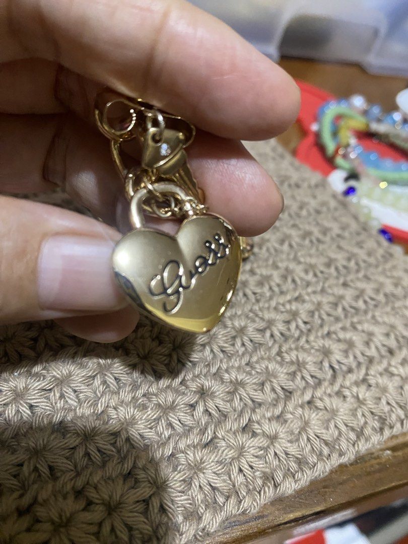 Guess Charm Bracelet (Category: Bracelets) located in Cavite. Submitted by momrocks (Listing ID 1461817436, Image 3). Description: gold-tone GUESS charm bracelet featuring dangling heart and key accents adorned with sparkling rhinestones.