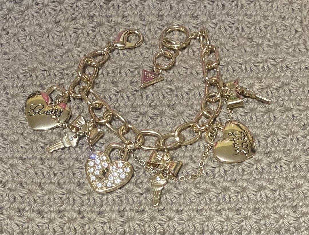 Guess Charm Bracelet (Category: Bracelets) located in Cavite. Submitted by momrocks (Listing ID 1461817436, Image 1). Description: gold-tone GUESS charm bracelet featuring dangling heart and key accents adorned with sparkling rhinestones.