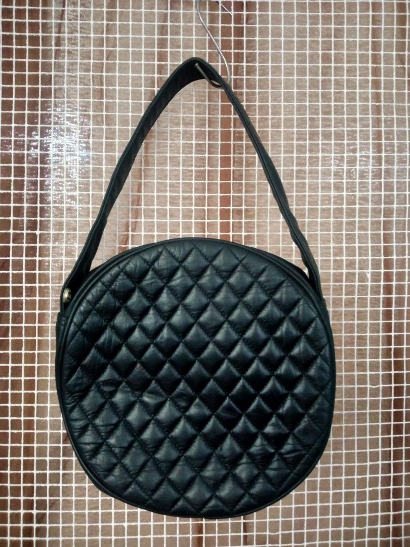 HANAMISUCO Quilted Round Shoulder Bag (Category: Luxury Bags & Wallets) located in Manila. Submitted by thepartypeopleph (Listing ID 1461869623, Image 2). Description: - Unique black quilted round shoulder/hand bag - Features a stylish gold-tone button on the front pocket - Secure zipper closure with branded HANAMISUCO pull - Adjustable shoulder strap for comfortable wear - Perfect for adding a touch of unique style to your everyday outfits in gr
