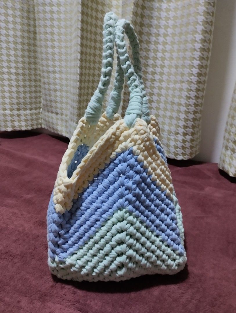Handmade Crochet Tote Bag (Category: Tote Bags) located in Mabalacat. Submitted by uniqlover (Listing ID 1461957016, Image 2). Description: - Cute handmade crochet tote bag - Features a stylish chevron pattern - Colors: Pastel blue, mint green, and cream - Braided mint green handles - Ideal for carrying your daily essentials - Unique and fashionable design.