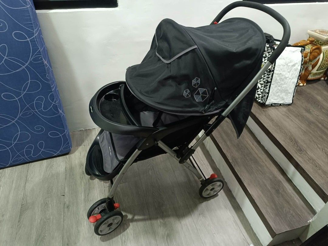 Happy Dino Baby Stroller (Category: Strollers) located in San Juan City. Submitted by angelo_padilla (Listing ID 1461952838, Image 1). Description: - Stylish black and grey stroller - Includes canopy for sun protection - Convenient tray with cup holder - Secure 5-point safety harness - Swivel wheels for effortless maneuverability - Folds compactly for easy storage and travel - Ideal for daily walks and on-the-go adventures.