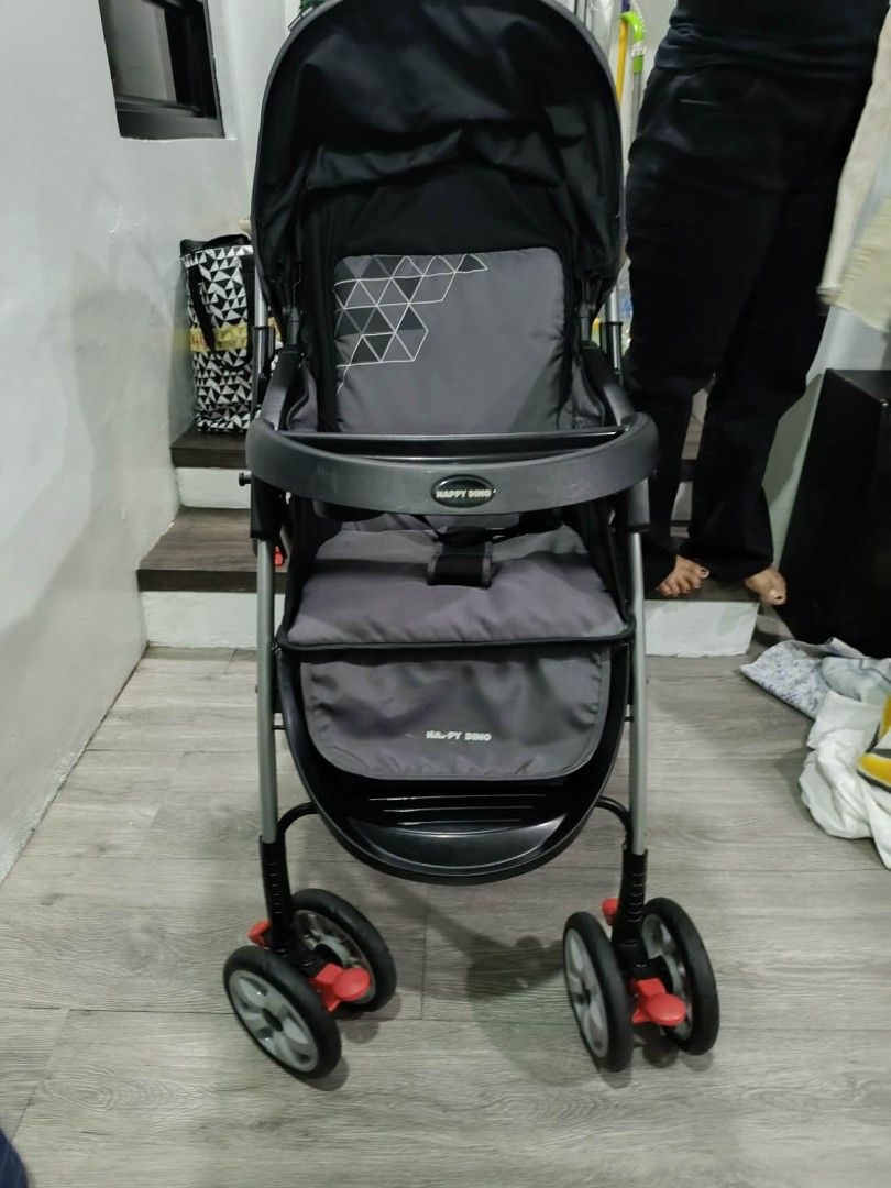 Happy Dino Baby Stroller (Category: Strollers) located in San Juan City. Submitted by angelo_padilla (Listing ID 1461952838, Image 2). Description: - Stylish black and grey stroller - Includes canopy for sun protection - Convenient tray with cup holder - Secure 5-point safety harness - Swivel wheels for effortless maneuverability - Folds compactly for easy storage and travel - Ideal for daily walks and on-the-go adventures.