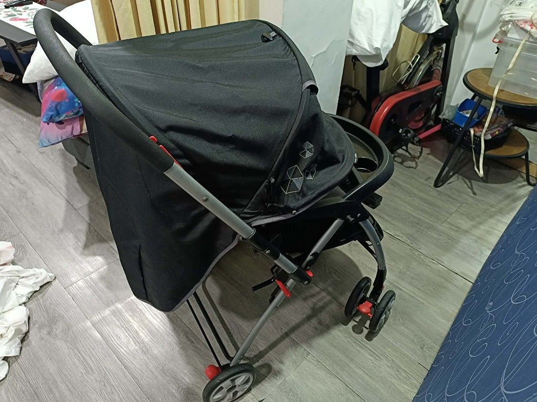 Happy Dino Baby Stroller (Category: Strollers) located in San Juan City. Submitted by angelo_padilla (Listing ID 1461952838, Image 3). Description: - Stylish black and grey stroller - Includes canopy for sun protection - Convenient tray with cup holder - Secure 5-point safety harness - Swivel wheels for effortless maneuverability - Folds compactly for easy storage and travel - Ideal for daily walks and on-the-go adventures.