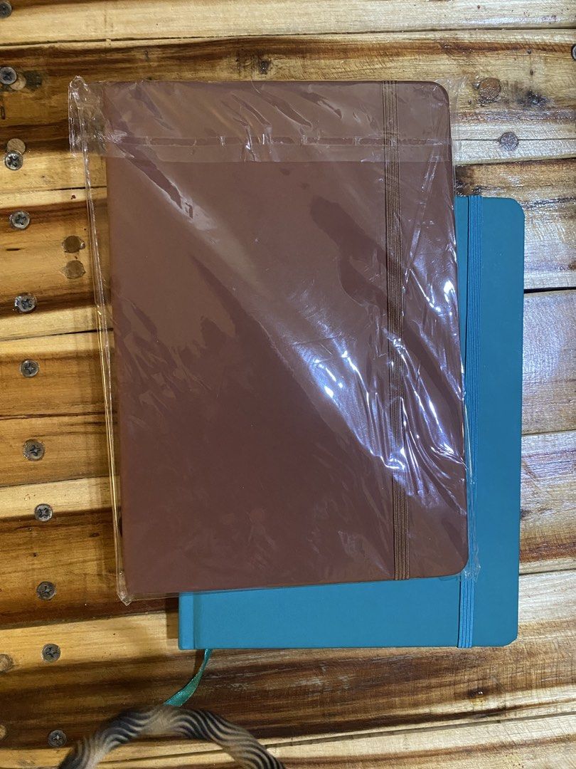 Hardbound Notebook Journal (Buy 1 take 1) (Category: Stationery & School Supplies) located in Cavite. Submitted by momrocks (Listing ID 1461823309, Image 1). Description: Brown and teal colored cover Smooth, hardbound cover Features Vertical elastic band on the right side for closure. Matching ribbon bookmark attached at the bottom..