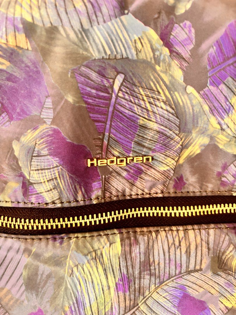 Hedgren Tropical Leaf Print Backpack (Category: Backpacks) located in Rizal (Liwan). Submitted by mesco2768266 (Listing ID 1461953200, Image 2). Description: - Hedgren backpack with a cool tropical leaf print - Features elegant gold hardware and zippers - Convenient front zip pocket for quick access - Secure side zip pocket - Adjustable straps for a comfortable fit - Ideal for everyday use or travel adventures.