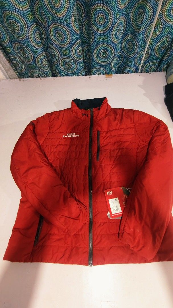 Helly Hansen Shore Excursions Puffer Jacket Red (Category: Coats, Jackets and Outerwear) located in Bulacan. Submitted by babz30261 (Listing ID 1461919154, Image 1). Description: - Red Helly Hansen puffer jacket - "Shore Excursions" printed on chest - Full zip front with pockets - Helly Hansen (HH) logo on sleeve and chest - Ideal for cooler weather - Brand new with tags attached.