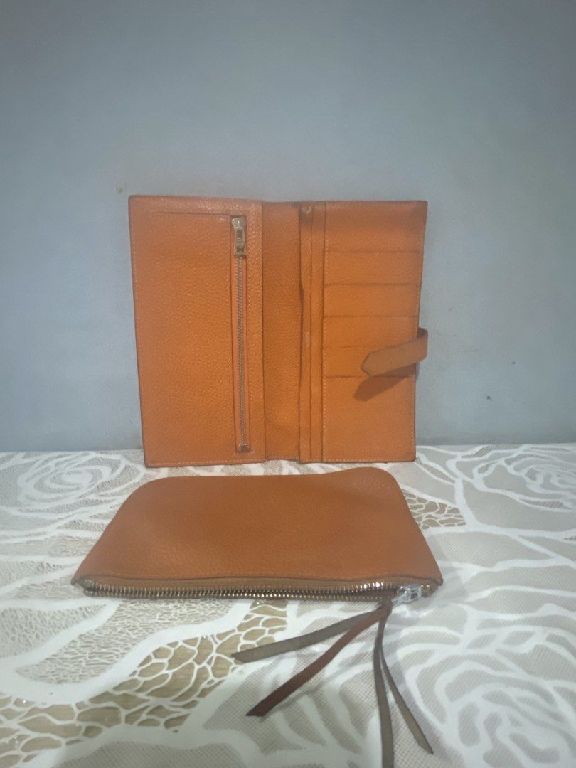 Hermes Paris Leather Wallet with Pouch (Category: Luxury Bags & Wallets) located in Cagayan de Oro. Submitted by ericlarkyl89146 (Listing ID 1461850110, Image 3). Description: - Genuine Hermes Paris brown leather wallet - Interior: Card slots and zippered compartment - Includes a matching leather pouch - Made in France - Silver-toned metal zipper and clasp.
