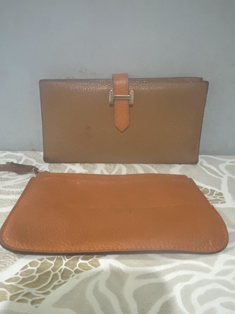 Hermes Paris Leather Wallet with Pouch (Category: Luxury Bags & Wallets) located in Cagayan de Oro. Submitted by ericlarkyl89146 (Listing ID 1461850110, Image 1). Description: - Genuine Hermes Paris brown leather wallet - Interior: Card slots and zippered compartment - Includes a matching leather pouch - Made in France - Silver-toned metal zipper and clasp.