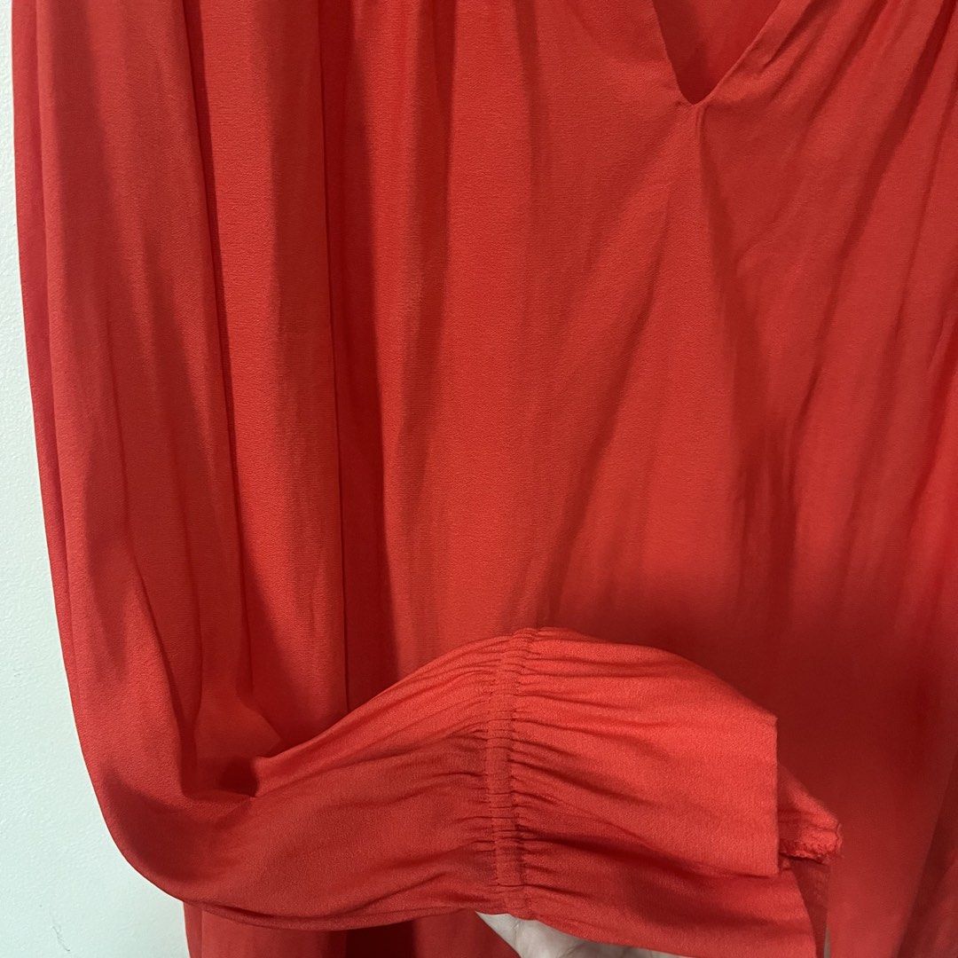 H&M Red Long Sleeve V-Neck Blouse (Category: Blouses) located in Quezon City. Submitted by shopnina (Listing ID 1461891638, Image 3). Description: - Brand: H&M - Color: Red - Style: Long sleeve blouse - Neckline: V-neck with gathered detail - Cuffs: Elasticated - Material: Lightweight, ideal for layering or solo wear - Versatility: Easily dressed up or down -missing button due to laundry but has an extra you can sew -last photo is an inspo.