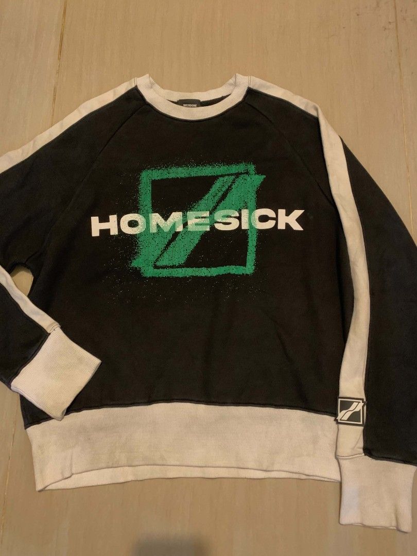 HOMESICK Black & White Raglan Sweatshirt (Category: Longsleeves) located in Manila. Submitted by ninningonz74690 (Listing ID 1461918304, Image 1). Description: - Black raglan sweatshirt with white sleeves and hem. - Features the HOMESICK logo graphic on the front. - Small graphic detail on the back. - Perfect for casual everyday wear..