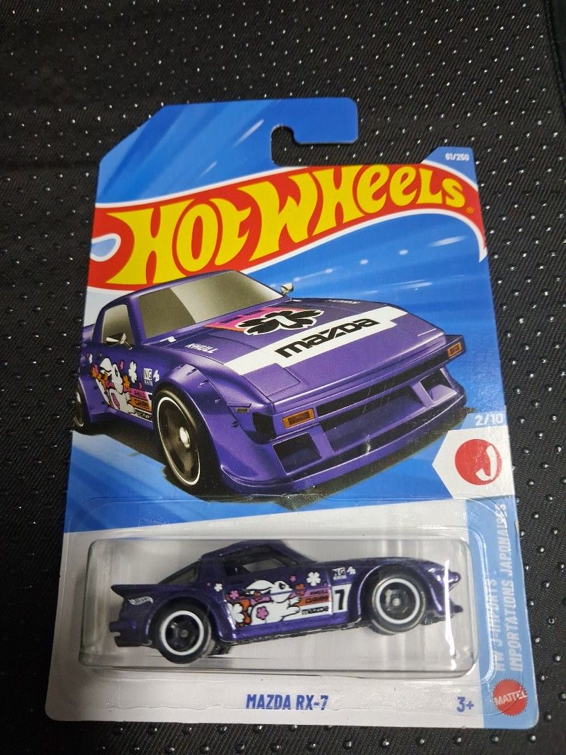 Hot Wheels Mazda RX-7 2/10 (Category: Vehicle & Diecast Models) located in Quezon City. Submitted by xserena (Listing ID 1461995724, Image 1). Description: - Hot Wheels Mazda RX-7 - Part of the 2/10 series - Striking purple color with unique rabbit graphics - Brand new in original packaging - Ideal for Hot Wheels collectors and Mazda RX-7 enthusiasts.