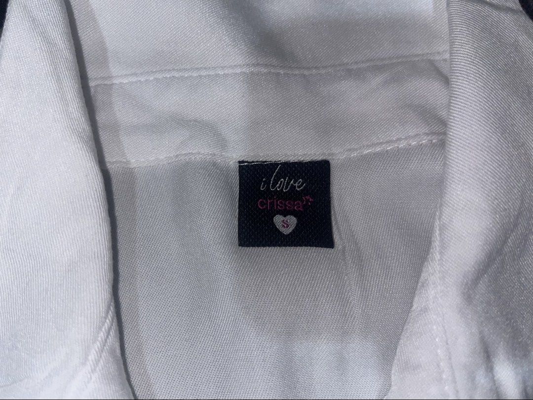 I Love Crissa White Button-Up Shirt (Category: Shirts) located in Manila. Submitted by whiiimsssy (Listing ID 1461936250, Image 2). Description: - Classic white button-up shirt - Brand: I Love Crissa - Size: S - Material: Cotton-Polyester blend - Versatile: Great for work or casual wear - Easy to style.