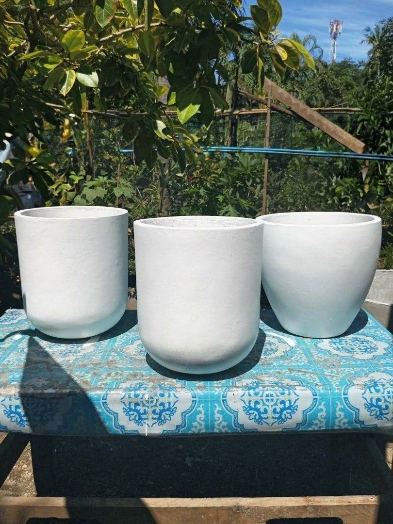 Indoor White Concrete Round Planters (Category: Pots & Planters) located in Manila. Submitted by lorioalexi45697 (Listing ID 1461918819, Image 1). Description: - Indoor white concrete planters - Smooth, matte finish - Rounded shape - Suitable for indoor or outdoor plants - Slightly varying sizes for visual appeal - Adds a minimalist touch to home or garden decor - Plants not included.